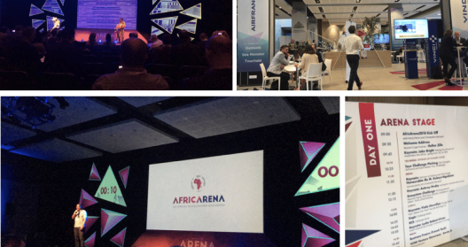 Conférence AfricArena avec scènes, stands et programme affiché.